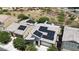 Aerial view of a house with solar panels on the roof, nestled among green trees at 2181 N 211Th Dr, Buckeye, AZ 85396