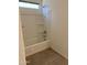 Clean bathroom with a shower-tub combination and neutral tiling at 2181 N 211Th Dr, Buckeye, AZ 85396
