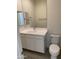 Well-lit bathroom featuring a vanity with storage and a commode at 2181 N 211Th Dr, Buckeye, AZ 85396
