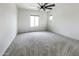 Cozy bedroom features neutral carpeting, white walls, and natural light streaming in from the windows at 2181 N 211Th Dr, Buckeye, AZ 85396