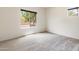Bright, spacious bedroom with carpeted floors and large windows, offering natural light and exterior views at 2181 N 211Th Dr, Buckeye, AZ 85396