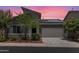 Inviting single-Gathering home with a desert landscape, a two-car garage, and solar panels for energy efficiency at 2181 N 211Th Dr, Buckeye, AZ 85396