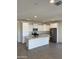 Spacious kitchen featuring white cabinetry, a large island, stainless steel appliances, and tile floors at 2181 N 211Th Dr, Buckeye, AZ 85396