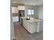 Bright kitchen showcasing a center island, stainless steel appliances, and ample counter space at 2181 N 211Th Dr, Buckeye, AZ 85396