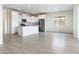 Open-concept kitchen with stainless steel appliances, an island, and tile flooring, perfect for modern living at 2181 N 211Th Dr, Buckeye, AZ 85396