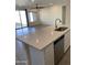 Open-concept kitchen and living area with a granite countertop, stainless steel dishwasher, and a ceiling fan at 2181 N 211Th Dr, Buckeye, AZ 85396