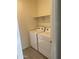 Convenient laundry room with a washer, dryer, and shelf, offering efficient utility space at 2181 N 211Th Dr, Buckeye, AZ 85396