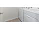 Laundry room features a white washer and dryer set with a neutral floor at 2181 N 211Th Dr, Buckeye, AZ 85396
