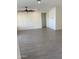 Open living space featuring tile flooring, ceiling fan, and neutral wall paint at 2181 N 211Th Dr, Buckeye, AZ 85396