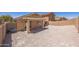 Spacious backyard featuring desert landscaping and a covered patio at 22010 W Solano Dr, Buckeye, AZ 85326