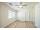 Comfortable bedroom featuring a ceiling fan, modern flooring, and a view of the neighborhood at 22010 W Solano Dr, Buckeye, AZ 85326