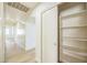 Bright hallway with storage shelving and a view of the home's interior at 22010 W Solano Dr, Buckeye, AZ 85326