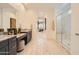 Luxurious bathroom featuring a double vanity, granite countertops, and a glass-enclosed shower at 23134 E Nightingale Rd, Queen Creek, AZ 85142