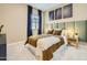 Relaxing bedroom with dark blue curtains and a velvet green headboard at 23134 E Nightingale Rd, Queen Creek, AZ 85142