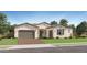 Charming single-story home featuring a brick driveway and a well-maintained front yard with lush landscaping at 23134 E Nightingale Rd, Queen Creek, AZ 85142