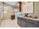 Convenient laundry room with cabinets and a granite countertop at 23134 E Nightingale Rd, Queen Creek, AZ 85142