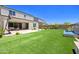 Large backyard with artificial turf, water feature, and covered patio at 24314 N 21St Pl, Phoenix, AZ 85024