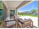 Covered patio features cushioned seating with beautiful view of artificial grass, and water feature at 24314 N 21St Pl, Phoenix, AZ 85024