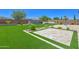 Backyard with pavers, artificial grass, water feature, and basketball hoop at 24314 N 21St Pl, Phoenix, AZ 85024
