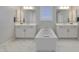 Luxurious bathroom featuring a soaking tub, dual vanities and modern fixtures for a spa-like experience at 24314 N 21St Pl, Phoenix, AZ 85024