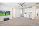 Bright, carpeted bedroom with recessed lighting, ceiling fan, TV, and built-in desk for added functionality at 24314 N 21St Pl, Phoenix, AZ 85024