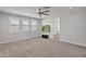 Spacious bedroom with large windows, plush carpet, and a ceiling fan for ultimate comfort and relaxation at 24314 N 21St Pl, Phoenix, AZ 85024
