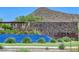 Stone Butte community waterfall with lush greenery and stone accents; a serene neighborhood entrance at 24314 N 21St Pl, Phoenix, AZ 85024