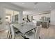 Bright dining area features stylish table set, sliding door access to patio and seamless flow into the modern kitchen at 24314 N 21St Pl, Phoenix, AZ 85024
