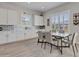 Dining area with elegant table, seating, and modern lighting, complemented by natural light and tasteful decor at 24314 N 21St Pl, Phoenix, AZ 85024