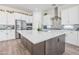 Open-concept kitchen with a large island, stainless steel appliances, and elegant backsplash at 24314 N 21St Pl, Phoenix, AZ 85024