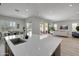 Modern kitchen with quartz countertops and open layout; seamlessly flows into living space at 24314 N 21St Pl, Phoenix, AZ 85024