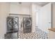 Functional laundry room equipped with high-end washer and dryer set and stylish patterned floor tiles at 24314 N 21St Pl, Phoenix, AZ 85024