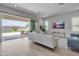 Bright living room featuring a large sliding glass door to backyard, neutral furniture, and modern decor at 24314 N 21St Pl, Phoenix, AZ 85024