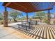 Community picnic area featuring shaded tables, stone pillars, and a well-maintained landscape at 24314 N 21St Pl, Phoenix, AZ 85024