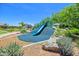 Community playground with blue slide and green turf hill at 24314 N 21St Pl, Phoenix, AZ 85024