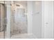Modern walk-in shower featuring elegant tile work and glass door providing spa-like bathroom experience at 24314 N 21St Pl, Phoenix, AZ 85024