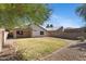 Backyard with block fence, covered patio, grass and gravel at 2625 E Beverly Rd, Phoenix, AZ 85042