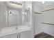 Bathroom features a single sink vanity and mirror, with walk-in closet and wood-look floors at 2625 E Beverly Rd, Phoenix, AZ 85042