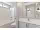 Bright, remodeled bathroom featuring white cabinetry and a shower/tub combo at 2625 E Beverly Rd, Phoenix, AZ 85042