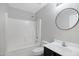 Bathroom with shower-tub combo and vanity sink with a round mirror at 2625 E Beverly Rd, Phoenix, AZ 85042