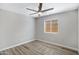 Bedroom with light gray walls, wood-look floors, ceiling fan and a window with blinds at 2625 E Beverly Rd, Phoenix, AZ 85042