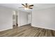 Large bedroom with neutral walls, wood-look floors, ceiling fan, and en-suite bath access at 2625 E Beverly Rd, Phoenix, AZ 85042