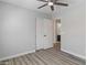 A bright bedroom featuring wood-look flooring and easy access to a bathroom at 2625 E Beverly Rd, Phoenix, AZ 85042