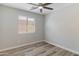 Bright bedroom features wood-look floors and ceiling fan for added comfort at 2625 E Beverly Rd, Phoenix, AZ 85042