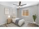 Serene bedroom featuring stylish decor, ceiling fan, soft natural lighting and neutral colors at 2625 E Beverly Rd, Phoenix, AZ 85042