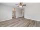 Inviting bedroom featuring wood-look flooring, bathroom access and ceiling fan at 2625 E Beverly Rd, Phoenix, AZ 85042