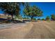 Grassy common area offers benches, walking paths, and mature trees, ideal for outdoor enjoyment at 2625 E Beverly Rd, Phoenix, AZ 85042