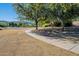 Neighborhood green area features a paved walking path with a bench and mature shade trees at 2625 E Beverly Rd, Phoenix, AZ 85042