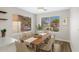Bright dining area with wood table and chairs situated by large windows, nice decor at 2625 E Beverly Rd, Phoenix, AZ 85042