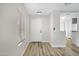 Welcoming entryway with wood floors and neutral paint, leading to the kitchen at 2625 E Beverly Rd, Phoenix, AZ 85042
